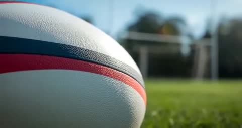Rugby Ball on Field with Focusing Transfers to Goalposts