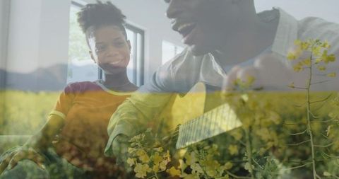 Couple sharing acoustic guitar, singing and smiling over yellow wildflower meadow double exposure