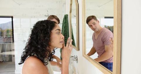 Couple sharing morning routine at bathroom vanity