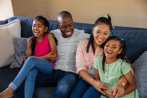 Happy Diverse Family Relaxing on Couch at Home