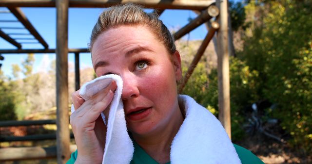 Woman Wiping Sweat While Resting After Outdoor Workout - Download Free Stock Images Pikwizard.com