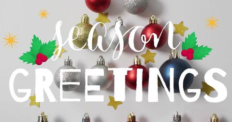 Season greetings christmas bauble flatlay with handlettered typography, holly & gold stars