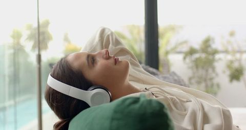 Tranquil Woman Relaxing with Headphones by Poolside