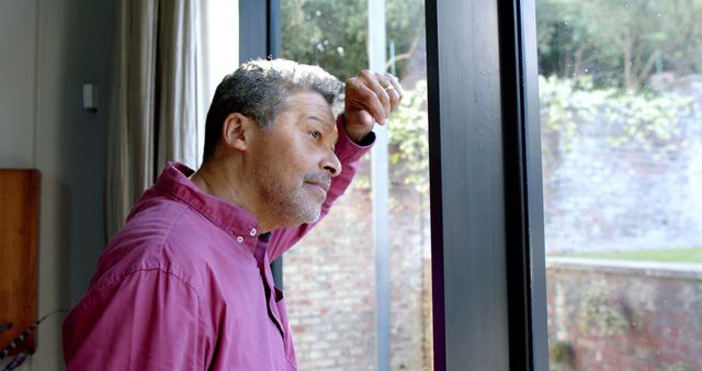 Senior Man Reflecting by Window at Home - Download Free Stock Images Pikwizard.com