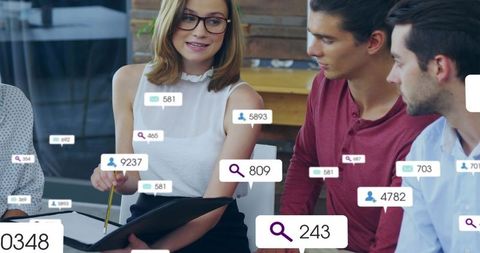 Young professionals discussing social media metrics and data analytics with ui badges