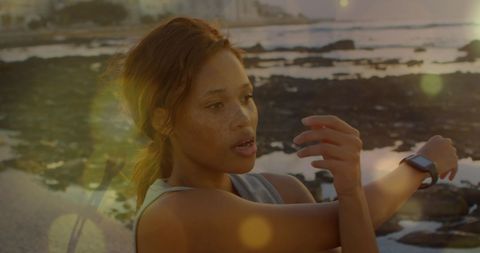 Woman Practicing Beach Stretches for Breast Cancer Awareness