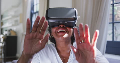 Elderly Woman Embracing Virtual Reality Experience at Home