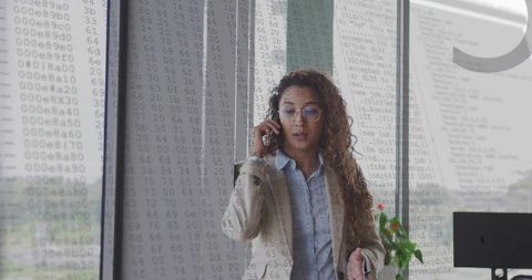Confident Businesswoman Discussing on Phone in Modern Office