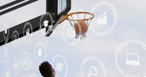 Athlete reaching for basketball on outdoor court with education and technology icons overlay