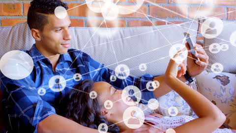 Connected Multiracial Couple Using Smartphone at Home