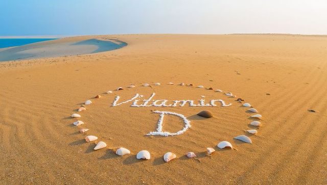 Sunlit seashell circle spelling vitamin d on rippling sand by azure lagoon wellness idea