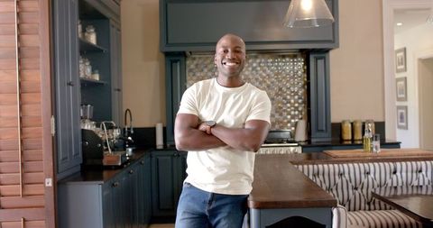 Confident Man Smiling in Contemporary Kitchen Environment