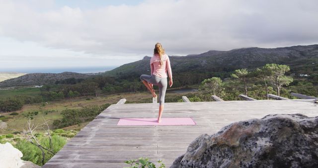 Woman Practicing Yoga Outdoors on Wooden Deck in Scenic Mountain Setting - Download Free Stock Images Pikwizard.com