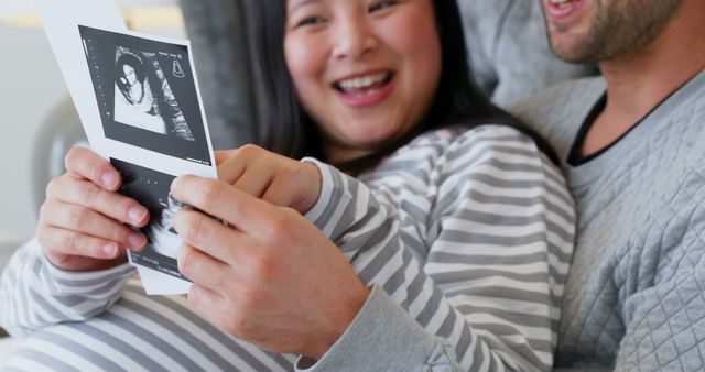 Excited Couple Viewing Ultrasound Scan of Baby at Home - Download Free Stock Images Pikwizard.com