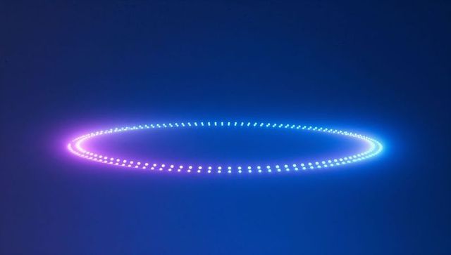 Futuristic led ring glowing with gradient lights in abstract space
