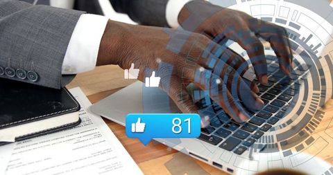 Professional hands typing on laptop with social media elements