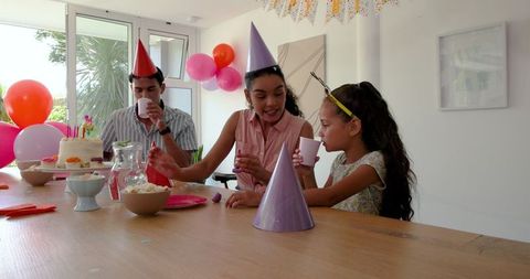 Family Celebrating Birthday at Home with Decor and Happiness