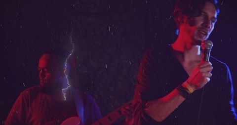 Passionate Rock Band Performance Under Dramatic Lighting