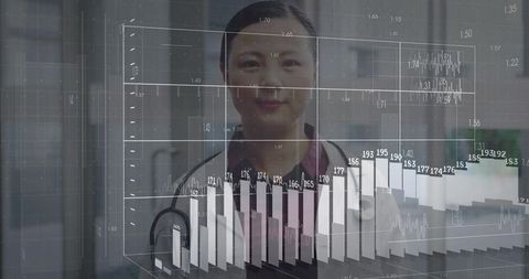 Nurse in burgundy scrubs analyzing medical charts and data