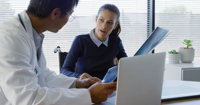 Doctor Consulting Patient Analyzing X-ray in Modern Medical Office - Download Free Stock Images Pikwizard.com