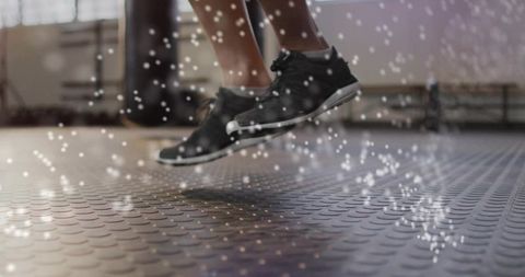 Athletic Feet Jumping in Gym with Chalk Particles
