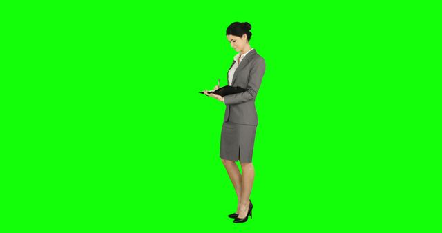 Businesswoman Taking Notes on Green Screen Background - Download Free Stock Images Pikwizard.com