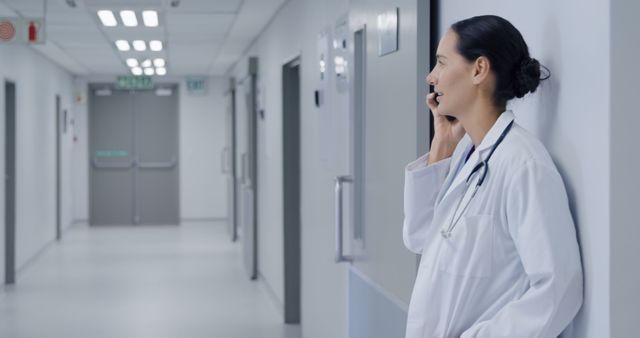 Doctor Talking on Phone in Hospital Hallway - Download Free Stock Images Pikwizard.com