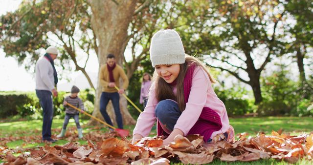 Image of happy caucasian daughter throwing autumn leaves in garden while family rakes them up behind. Family, domestic life and togetherness concept digitally generated image.