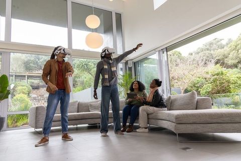 African american family exploring virtual reality at home using vr headsets and tablet