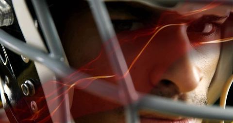 Intense focus football player in helmet with light effects