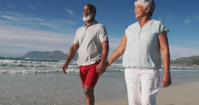 Senior african american couple walking and holding hands at the beach - Download Free Stock Photos Pikwizard.com