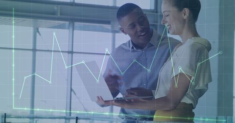 Diverse team analyzing financial data on digital tablet in modern office
