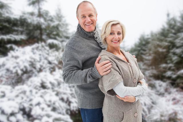 Digital composite of Romantic senior couple wearing sweaters during winter