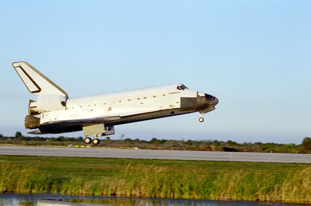 STS089-S-016 (31 Jan. 1998) --- The space shuttle Endeavour is just about to touch down on Runway 15 of the Shuttle Landing Facility (SLF), at Kennedy Space Center (KSC), to successfully complete an almost-nine-day mission in Earth orbit. Main gear touchdown was at 5:35:09 p.m. (EST) Jan. 31, 1998. Complete wheel stop occurred at 5:36:19 p.m., making a total mission elapsed time of eight days, 19 hours, 48 minutes and four seconds. The 89th space shuttle mission marked the 42nd (and 13th consecutive) landing of a space shuttle at KSC. Onboard were astronauts Terrence W. Wilcutt, Joe F. Edwards Jr., Bonnie J. Dunbar, David A. Wolf, James F. Reilly and Michael P. Anderson and the Russian Space Agency's (RSA) cosmonaut Salizhan S. Sharipov.  Andrew S. W. Thomas had earlier gone into space aboard the Endeavour to replace Wolf aboard Russia's Mir Space Station. The ninth and final shuttle/Mir docking mission in the spring of this year will retrieve Thomas from the Mir complex. Photo credit: NASA