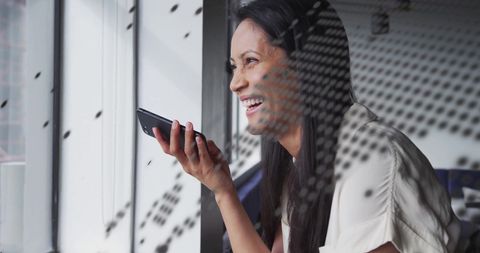 Businesswoman Engaging on Smartphone with Digital Globe Overlay