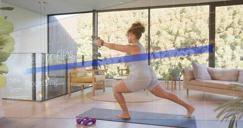 Sunlit living room home workout performing forward lunge barefoot in fitted activewear
