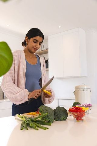 Woman Preparing Vegetables in Modern Home Kitchen
