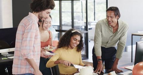 Diverse team celebrating birthday in modern office