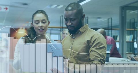 Colleagues Analyzing Financial Graphs in Modern Office