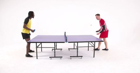 Athletes Competing Focus on Table Tennis Game