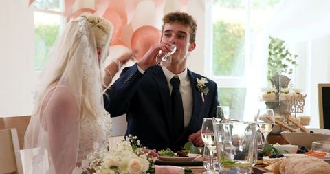Bride and Groom Celebrating Wedding with Toast at Indoor Reception