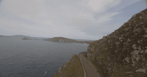 transparent coastal mountain road along cliffs and tranquil sea - Download Free Stock Videos Pikwizard.com