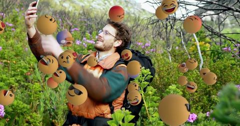 Hiker Taking Selfie in Nature Surrounded by Floating Emojis