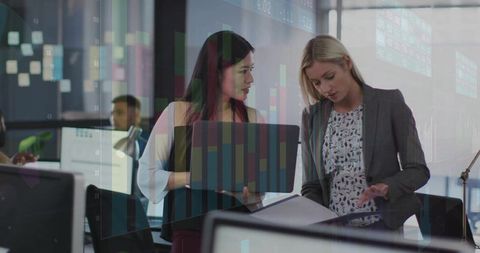 Professional Businesswomen Collaborating in Modern Office Environment