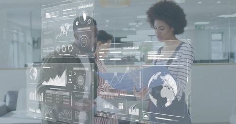 Team collaborating over holographic data dashboards in office for business analytics