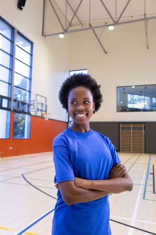 Female Athlete on Indoor Basketball Court in Blue Sportswear