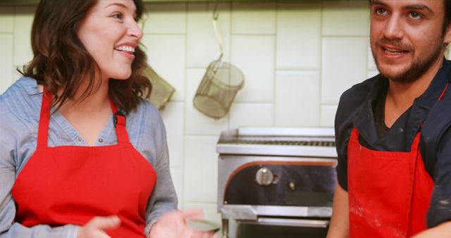 Smiling Chefs Wearing Red Aprons in Kitchen - Download Free Stock Images Pikwizard.com