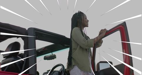 Woman Embracing Freedom Standing in Red Convertible