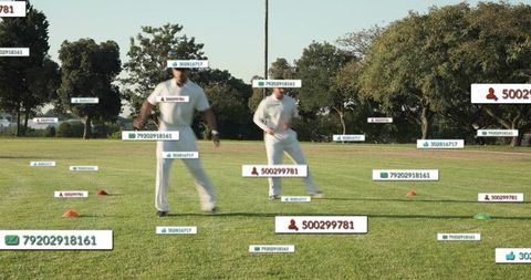 Running cricket duo practicing on grass field with ar performance labels and training cones