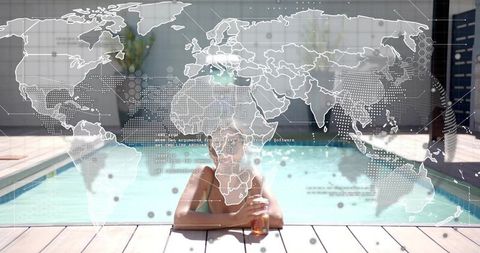 Leaning woman in green swimsuit holding bottle at pool with transparent world data overlay